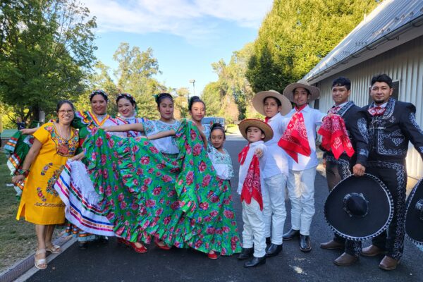 Group photo of Cville Sabroso 2023 dancers and performers wearing traditional attire.